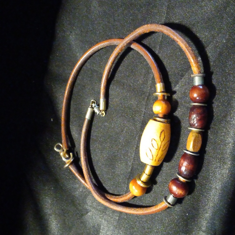 2 leather and wood necklaces.